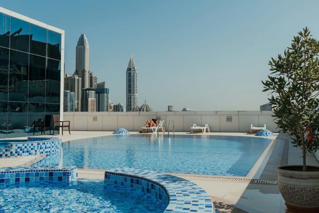 A large swimming pool with a view of a city