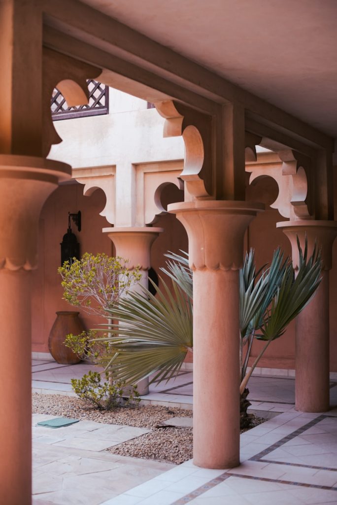 An elegant courtyard with decorative arches and columns.
